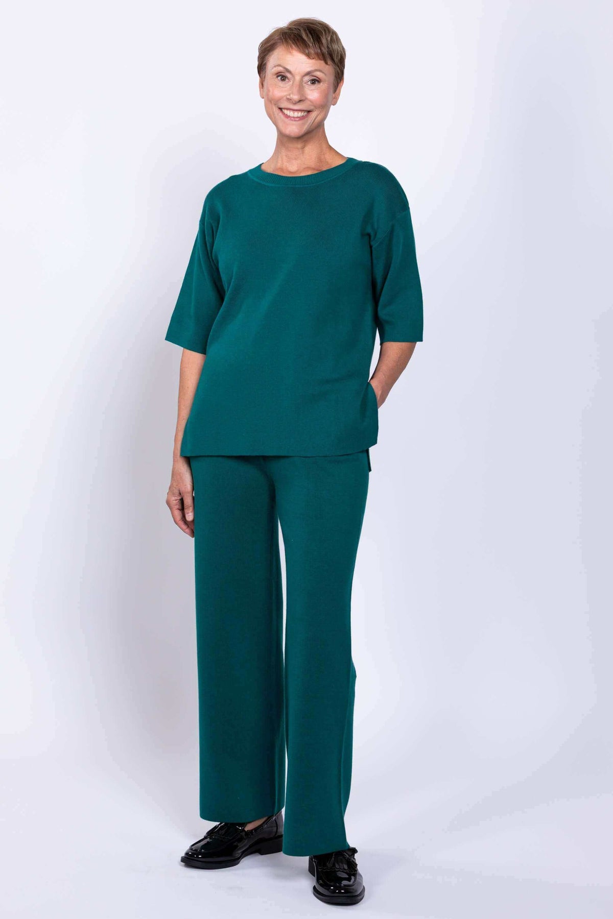 Full body view of woman in teal Bailey Sweater set, front angle