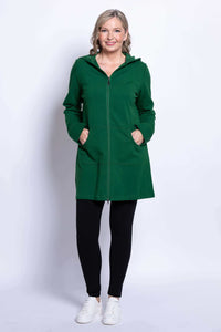 Woman in green jacket with hood and front zip, hands in pockets, full length
