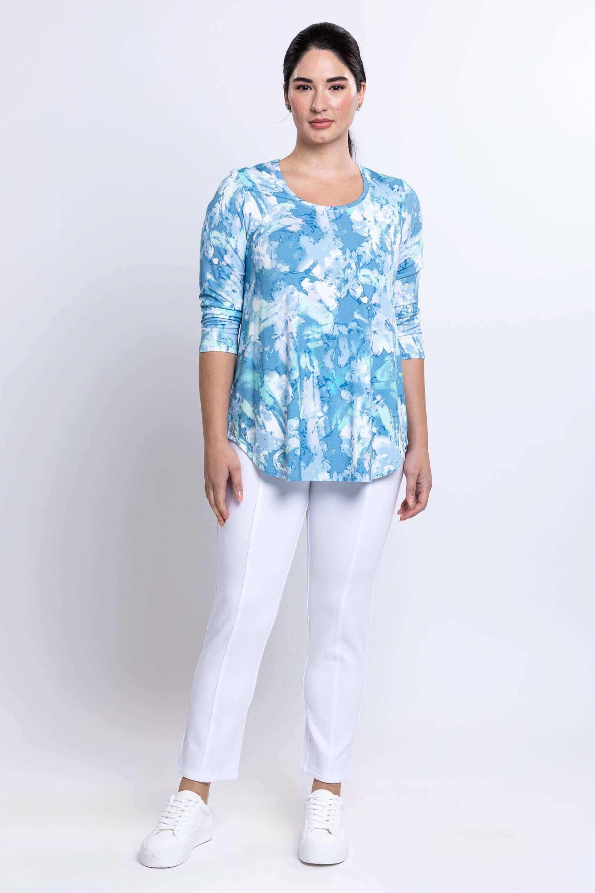 Full front view of model in blue watercolor Jazz Top and white pants