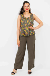 Full body view of model in Ginny Floral Peplum Tank and wide-leg olive pants