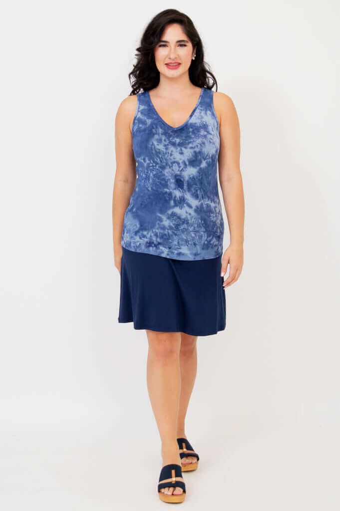 Model in indigo tie dye reversible bamboo tank and navy skirt, full outfit, front view
