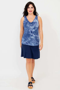 Model in indigo tie dye reversible bamboo tank and navy skirt, full outfit, front view