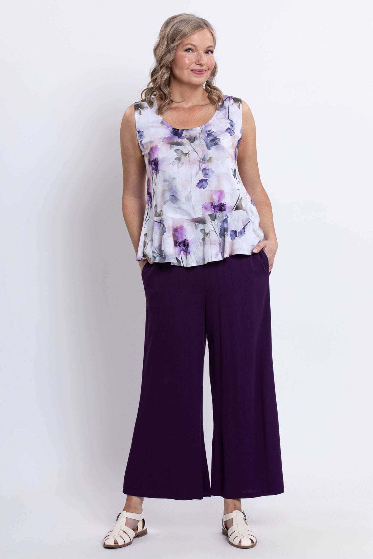 Model showing full outfit with Ginny floral peplum tank top and wide-leg purple pants