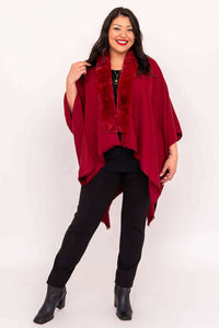 Full body view of woman in scarlet wrap, black pants, and ankle boots