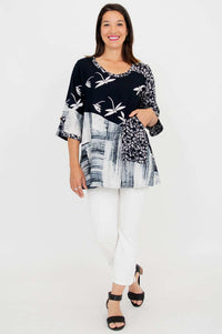 Full length view of woman in Palace Blouse with white pants and black sandals