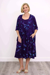 Woman in a purple dragonfly print jacket and matching dress, posing front view