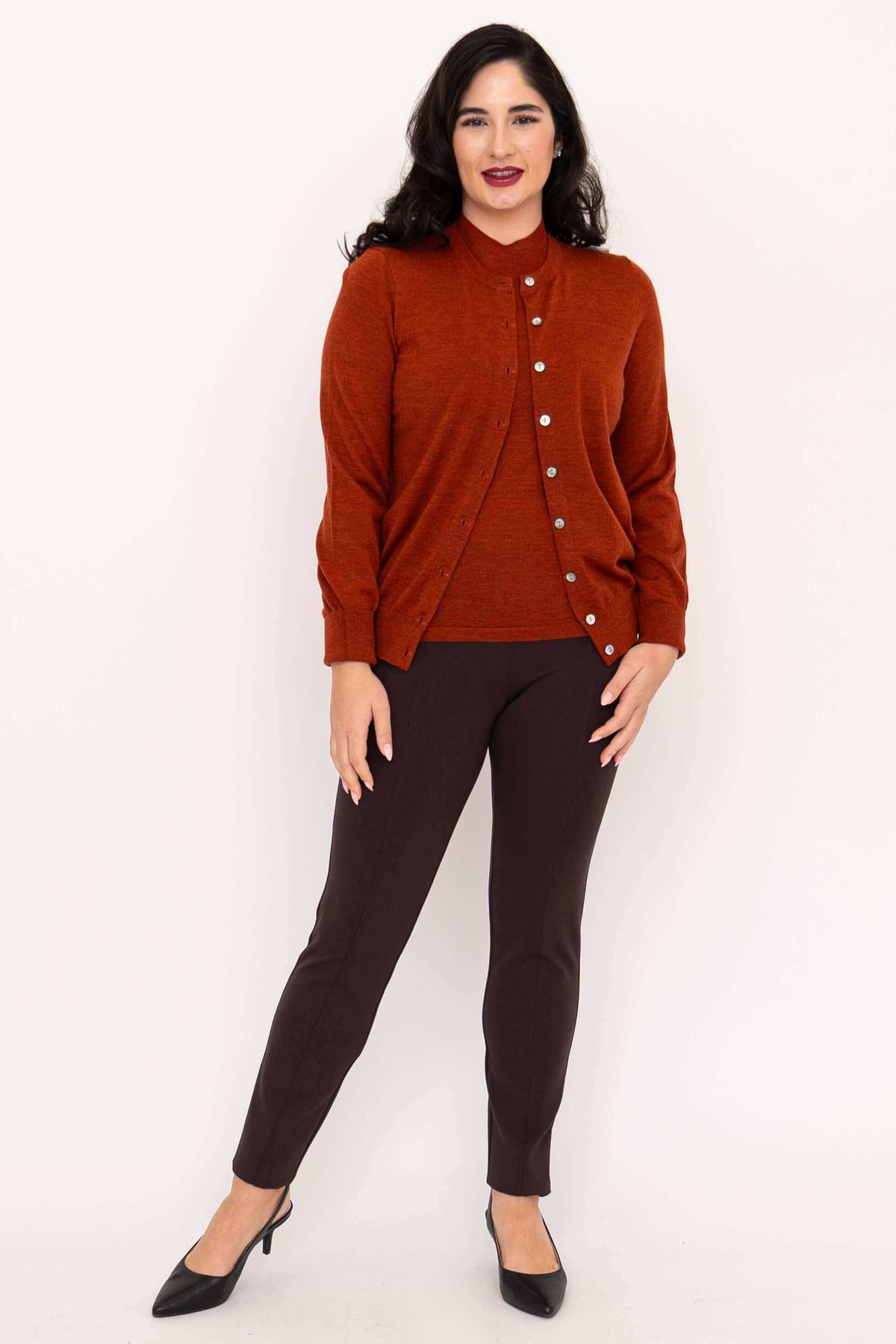 Full body view of woman in rust Merino wool cardigan and brown pants