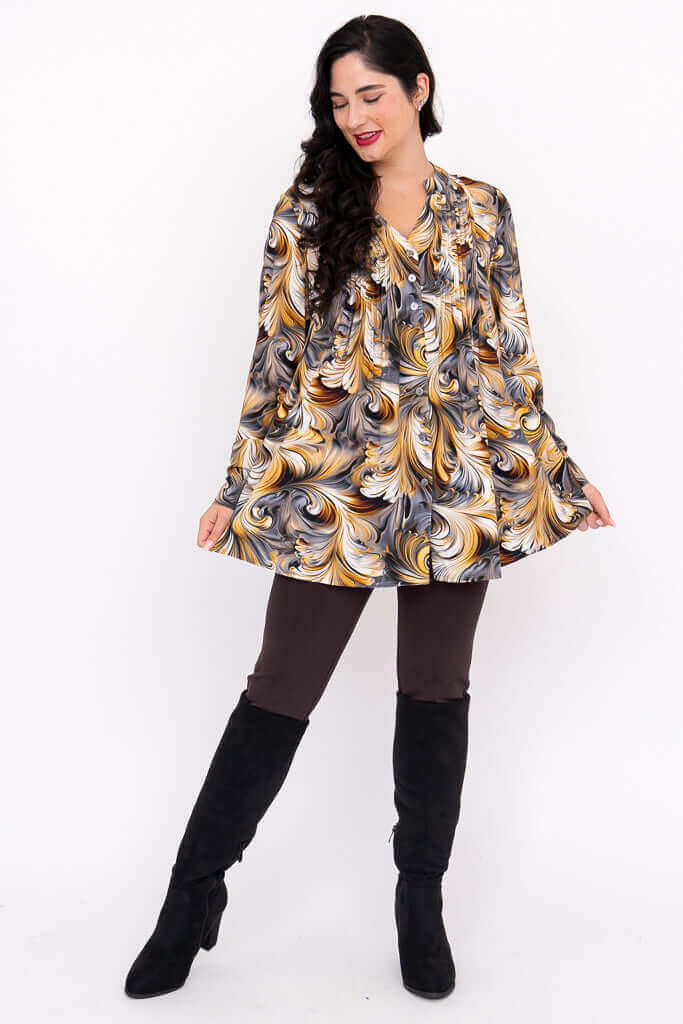 Woman modeling Margate swirl blouse outfit with leggings and black boots