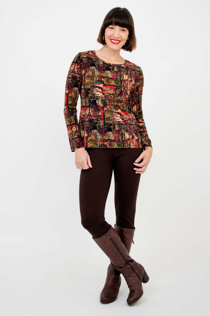 Model crossing legs showing full outfit with Mariah printed tee and boots