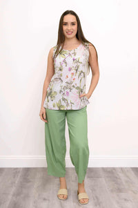Woman in floral botanical print tank top and green wide-leg pants, full front view