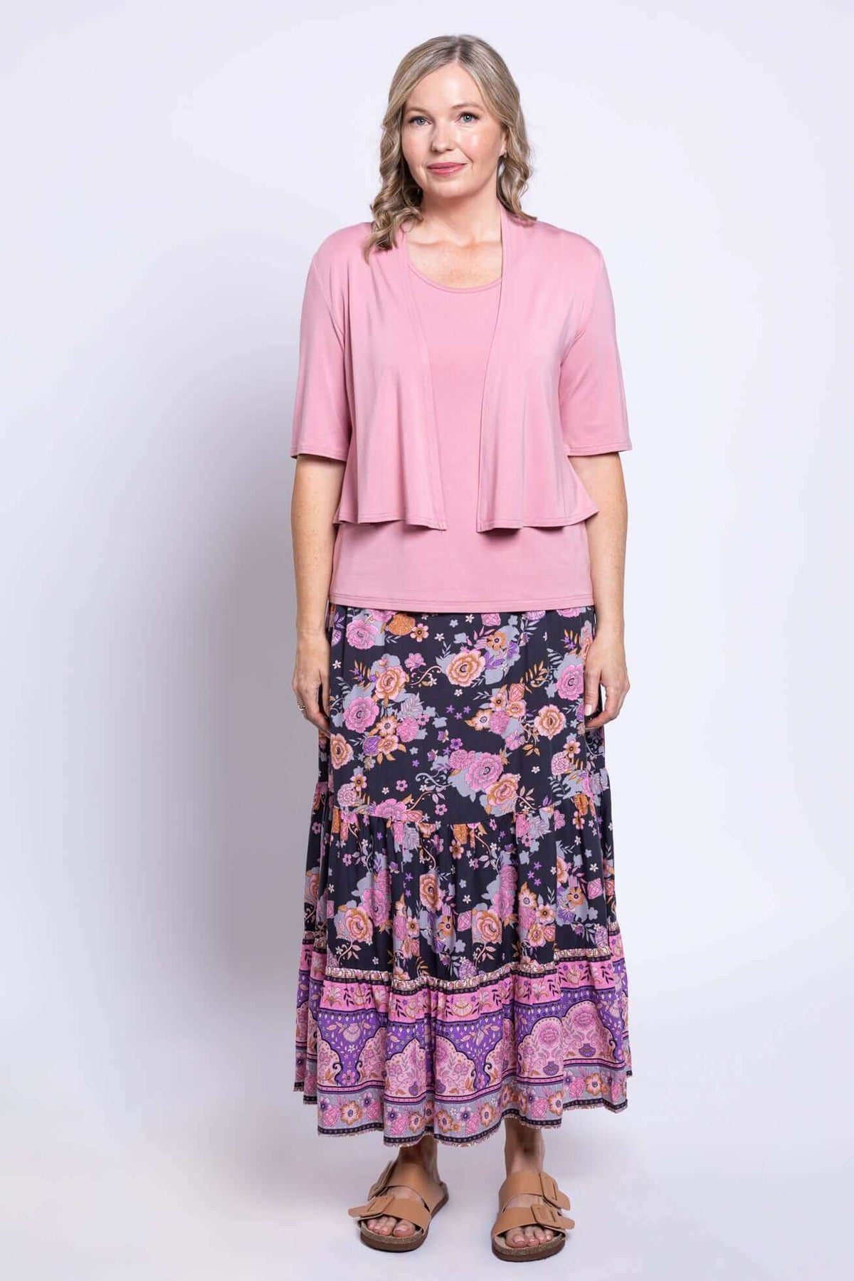 Woman in pink top and cardigan showing full boho floral maxi skirt outfit