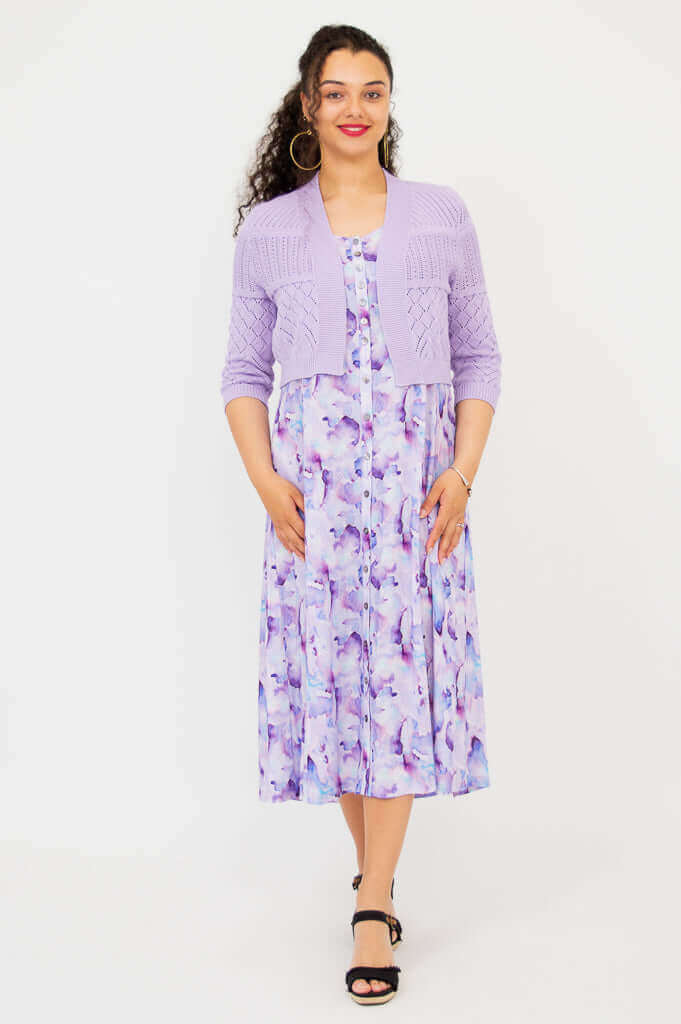Full-length view of model in lilac pointelle cropped cardigan and watercolor print midi dress