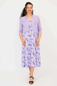 Full-length view of model in lilac pointelle cropped cardigan and watercolor print midi dress