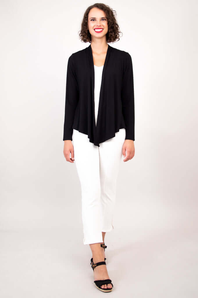 Full view of model in black open-front cardigan and white cropped pants