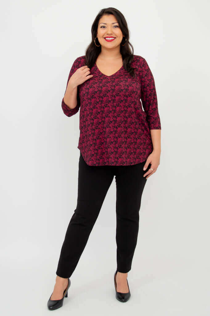 Full front view of model in coral print V-neck bamboo top and black pants