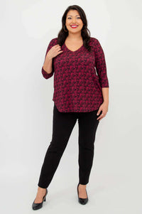 Full front view of model in coral print V-neck bamboo top and black pants