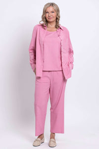 Full view of woman in pink linen-blend shirt and pants
