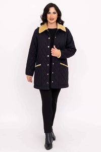 Woman walking in black quilted coat with tan collar and trim