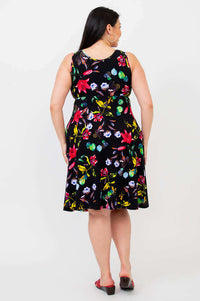 Back view of woman wearing sleeveless black fit and flare floral dress