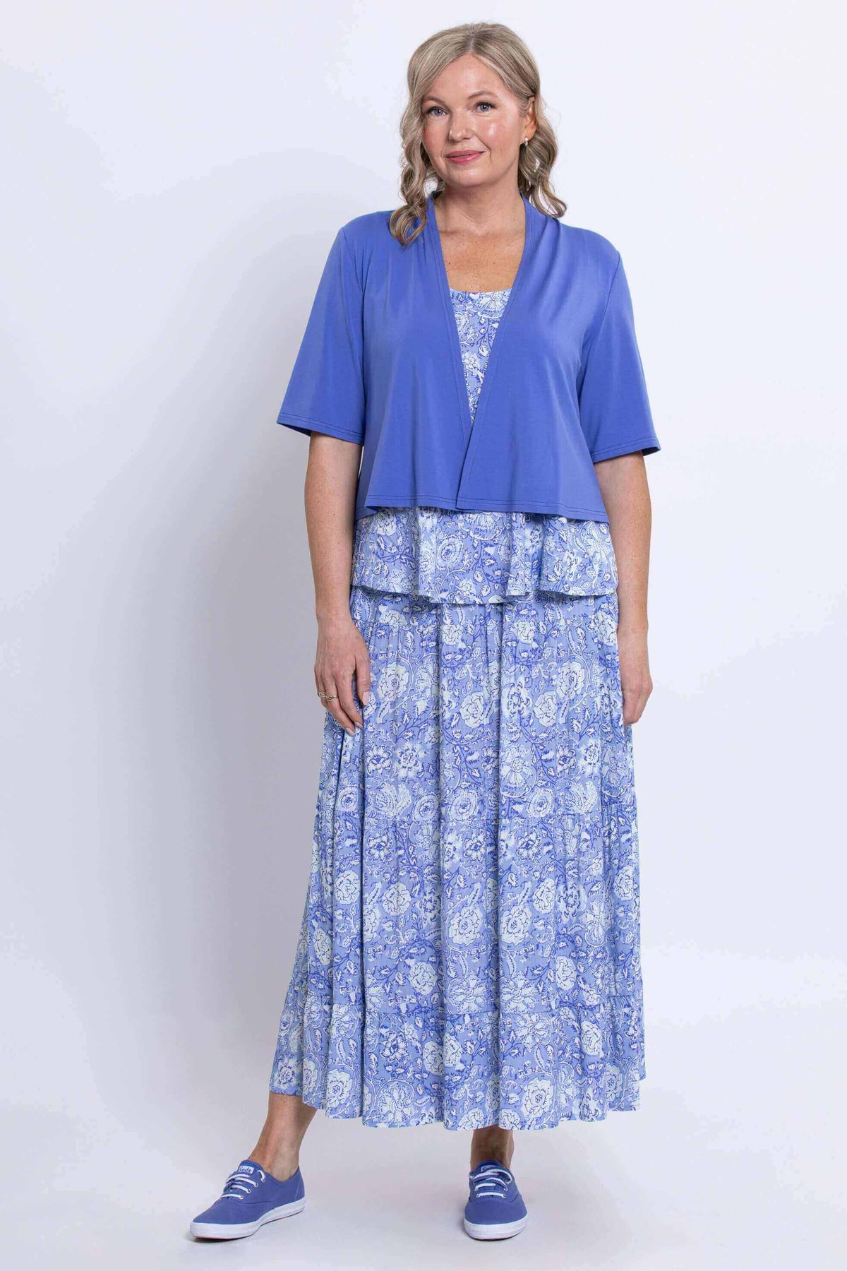 Woman layering the Ginny Tank and skirt with a blue short-sleeve cardigan
