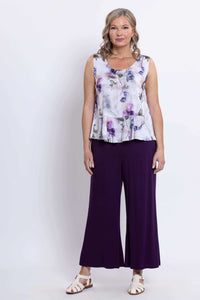 Model in Ginny floral peplum tank, standing facing forward with hands down