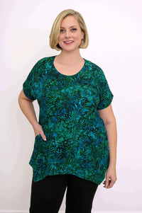 Woman wearing green and blue leafy print tunic top with relaxed fit and round neckline