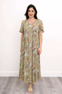Woman wearing a green floral maxi dress with empire waist and flutter sleeves