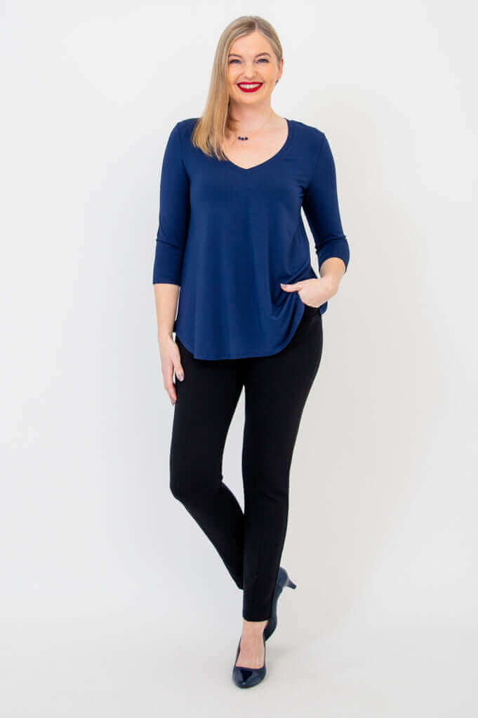 Woman posing with hand in pocket, navy Jackie V-neck bamboo top