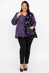 Model with hand in pocket of black and purple V-neck button top