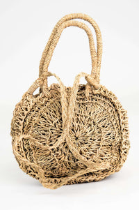 Back view of a round woven rattan bag with double handles and braided detailing