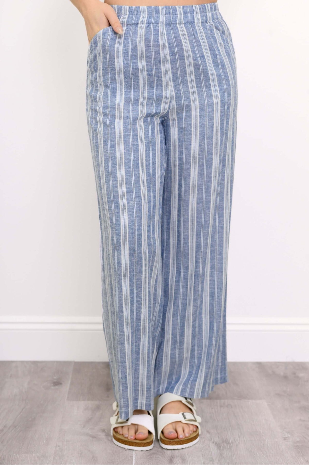 Hands in pockets front view of Parker blue striped wide-leg pants