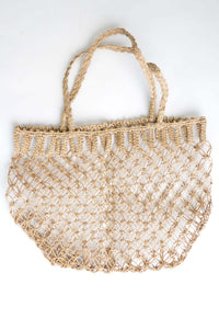 Handwoven rattan summer bag with an open mesh design and braided handles