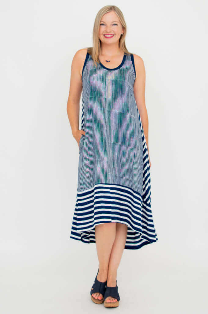 Front view of navy and white hi-lo dress with pockets styled for summer