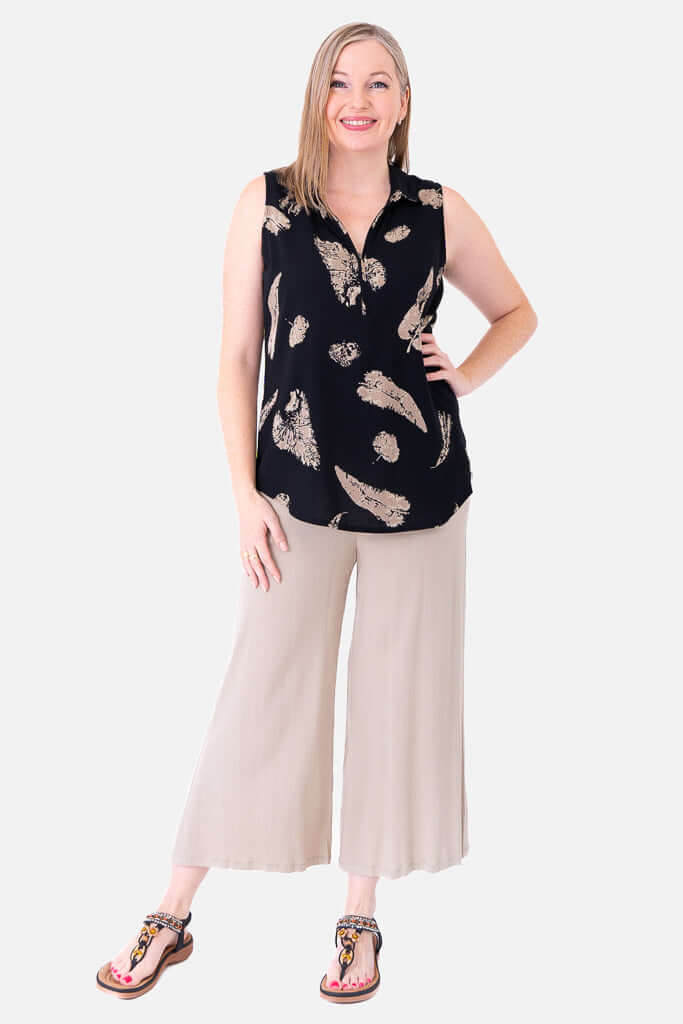 Second model in Hula zip tank top and wide leg light beige pants