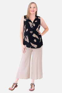 Second model in Hula zip tank top and wide leg light beige pants