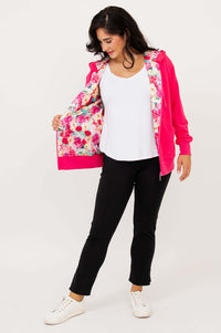 Woman holding open a fuchsia hoody to display colorful floral lining inside