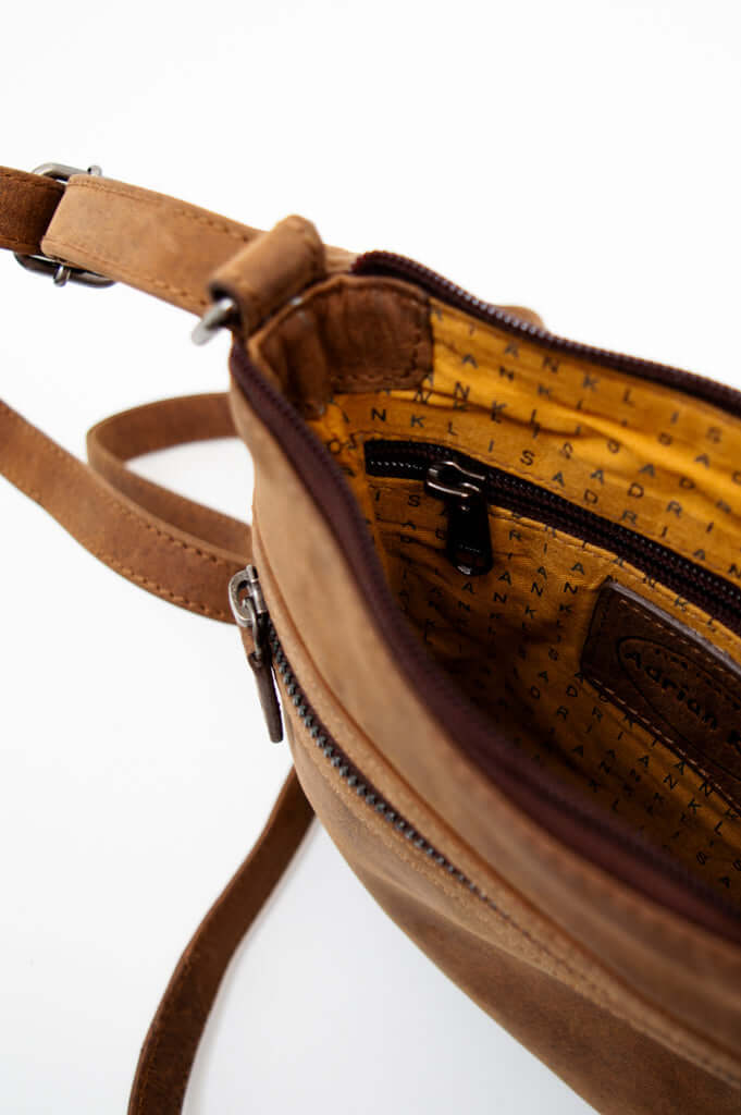 Close-up of the pouch's lined interior showing zippered pocket and logo detail