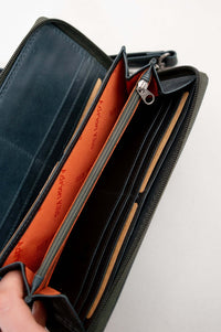 Interior view of leather wallet with orange lining and zippered compartments
