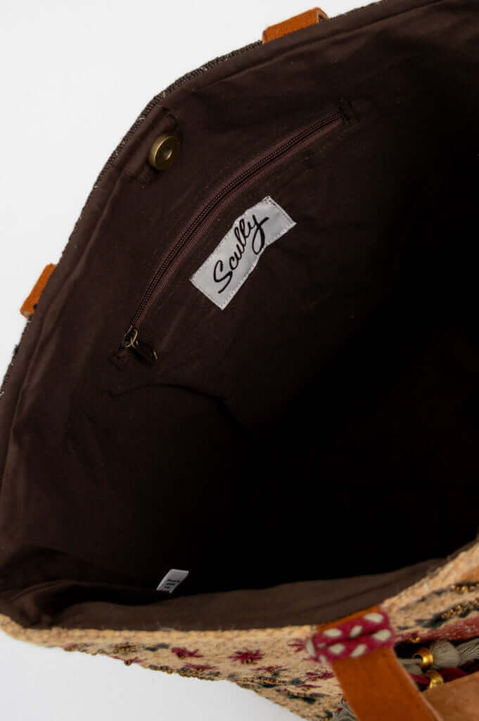 Interior view of the tote bag with zippered pocket and brand label
