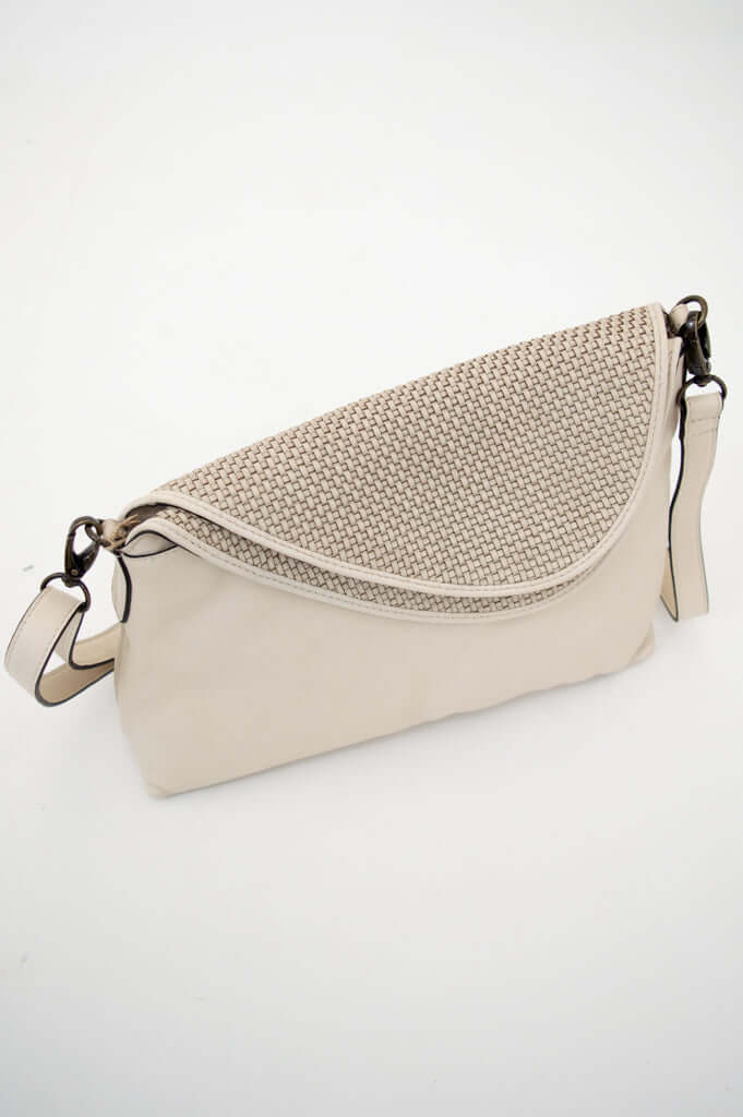 Ivory crossbody bag with woven flap and adjustable strap on white background