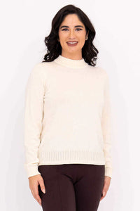 Woman wearing an ivory mock neck sweater with cable knit details, front view