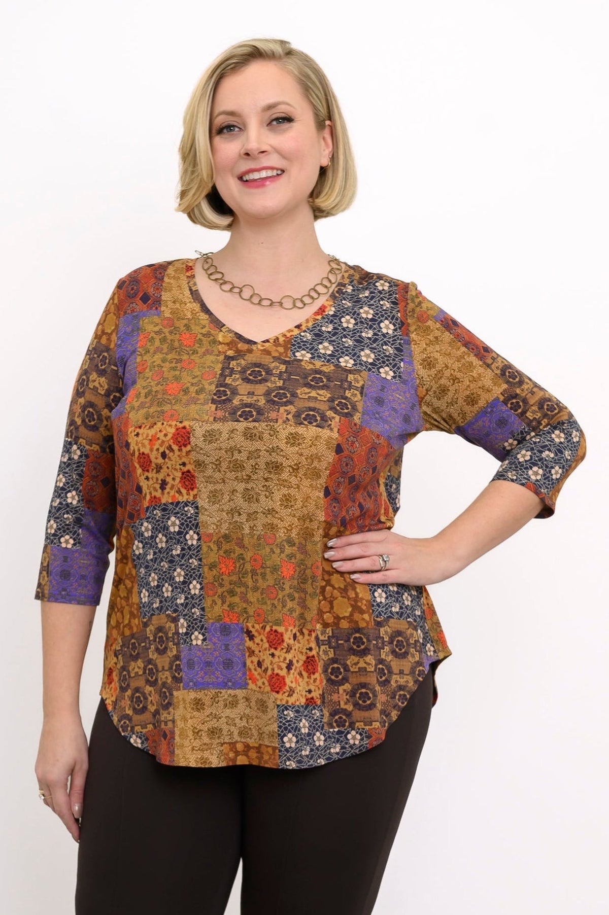Side view of a flowy yellow geometric print bamboo blouse with 3/4 sleeves and a gentle A-line silhouette.