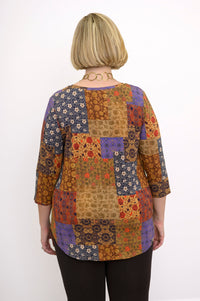 Back view of a yellow patchwork bamboo top showing the relaxed fit and hip-covering hemline length.