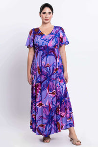 Front view of woman wearing purple abstract floral maxi dress with flutter sleeves