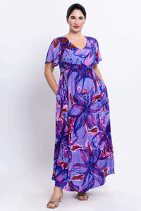 Side-front view of purple abstract floral maxi dress featuring empire waist