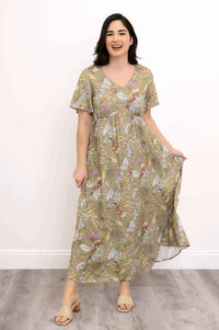Woman laughing in a long green floral dress with empire waist and flutter sleeves