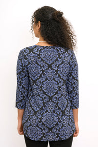Back view of a woman wearing an indigo patterned 3/4 sleeve bamboo top with a clean shoulder fit.