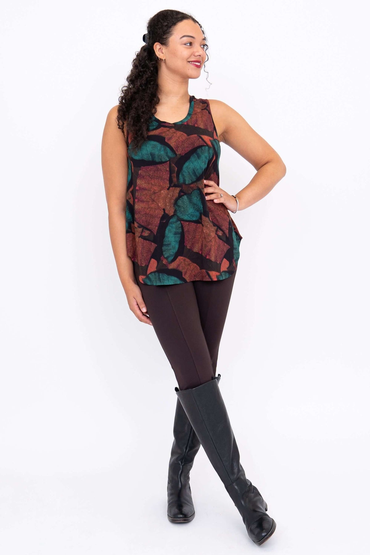 Model posing in Jazz tank top with hand on hip, showing autumn leaf print