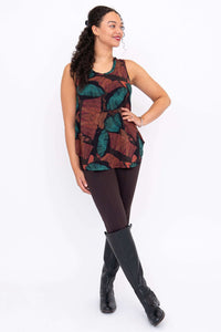 Model posing in Jazz tank top with hand on hip, showing autumn leaf print