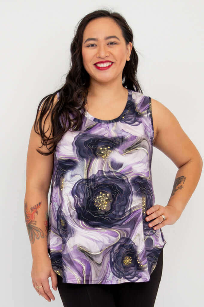 Woman wearing sleeveless bamboo tank in purple lotus flow floral print, front view